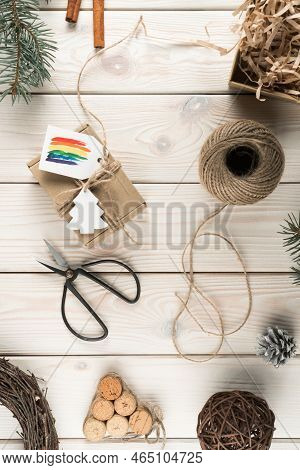 Vertical Composition Of Natural, Organic, Fabric Wrapped Box With Rainbow Label, Festive Cards With 