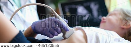 Doctor Conducting Ultrasound Examination Of Internal Organs Of Child In Clinic. Diagnosis And Treatm