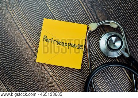 Concept Of Perimenopause Write On Sticky Notes With Stethoscope Isolated On Wooden Table.