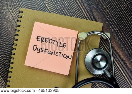 Concept Of Erectile Dysfunction Write On Sticky Notes Isolated On Wooden Table.