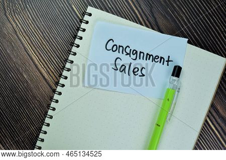 Concept Of Consignment Sales Write On Sticky Notes Isolated On Wooden Table.