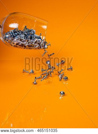 Dropped Many Metal Self-tapping Screws Made Of Steel In A Glass, In Bucket Jar. Self-tapping Screw F