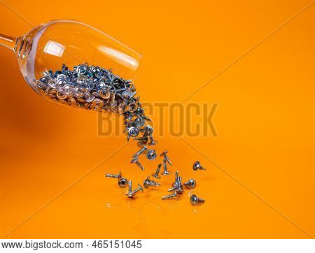 Dropped Many Metal Self-tapping Screws Made Of Steel In A Glass, In Bucket Jar. Self-tapping Screw F