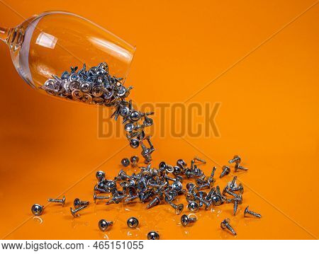 Dropped Many Metal Self-tapping Screws Made Of Steel In A Glass, In Bucket Jar. Self-tapping Screw F