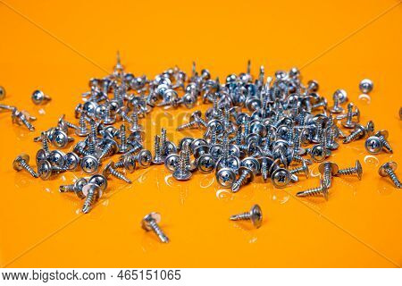 Many Metal Self-tapping Screws Made Of Steel In A Glass, In Bucket Jar. Self-tapping Screw For Metal