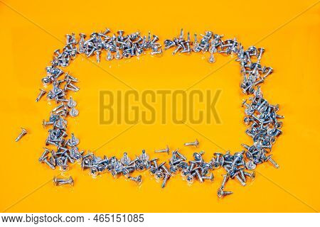 Many Metal Self-tapping Screws Made Of Steel In A Glass, In Bucket Jar. Self-tapping Screw For Metal