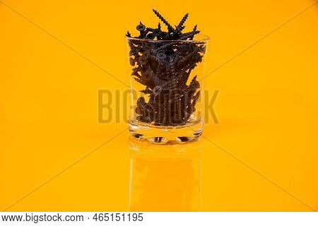 Many Metal Self-tapping Screws Made Of Steel In A Glass, In Bucket Jar. Self-tapping Screw For Metal
