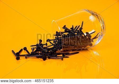 Many Metal Self-tapping Screws Made Of Steel In A Glass, In Bucket Jar. Self-tapping Screw For Metal