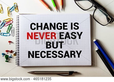 Wooden Blocks With Words 'change Is Never Easy But Necessary.