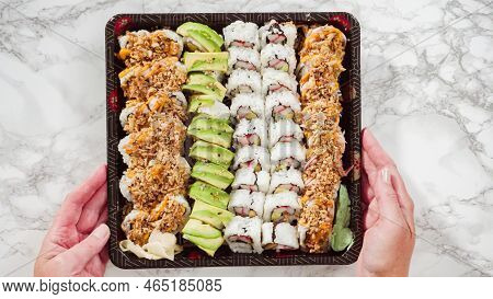 Flat Lay. Pre-packaged Variety Of Sushi And Sushi Rolls In A Plastic Tray.