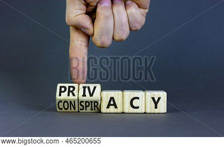 Privacy Or Conspiracy Symbol. Businessman Turns Wooden Cubes And Changes The Word Conspiracy To Priv