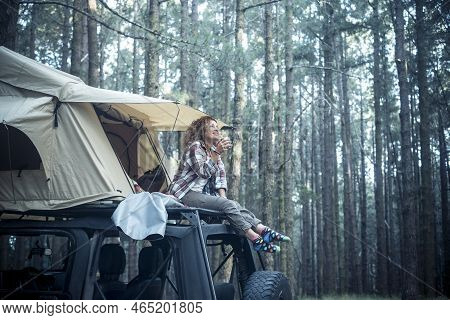 Happy Free Beautiful People Caucasian Woman Sit Down On The Roof Of The Car With Tent Mounted On It 