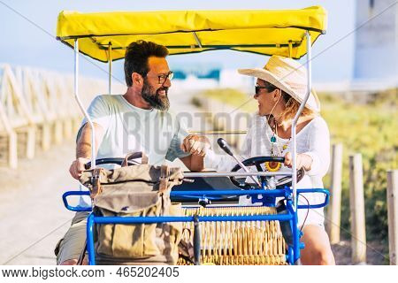 Adult Cheerful Caucasian People Couple Having Fun Outdoor With Vacation Double Bike -together In Rel