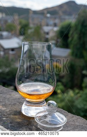 Glass Of Single Malt Scotch Whisky Served On Old Window Sill In Scottisch House With View On Old Par