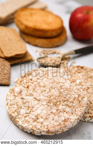 Rice Cakes And Rusks On White Marble Table, Closeup