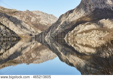 Picturesque Reservoir And Mountain Landscape In Riano. Mirror Effect. Spain
