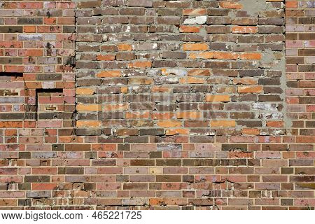 Background, Brick Wall Made Old German Red Burnt Brick With Traces Bullets And Shrapnel After World 