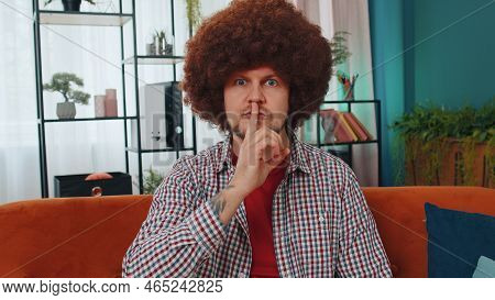 Shh Be Quiet, Hush Please. Adult Caucasian Man Presses Index Finger To Lips Makes Silence Hush Gestu