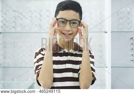Smart Young Buy Student In Striped Polo T-shirt Happy Trying Out, Testing, And Choosing New Eyeglass
