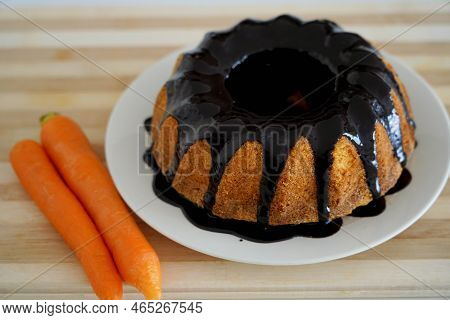Carrot Cake With Chocolate Icing On Wooden Table. Brazilian Cake.