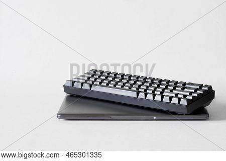 Trendy Black Mechanical Computer Keyboard For Esports And A Small Laptop On A White Background. Wire