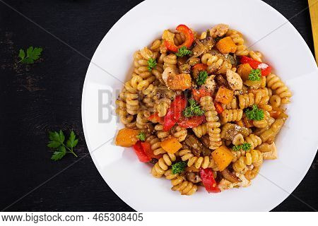 Vegetable Pasta Fusilli Corti Bucati With Eggplant, Sweet Pepper And Chicken In White Plate On Dark 