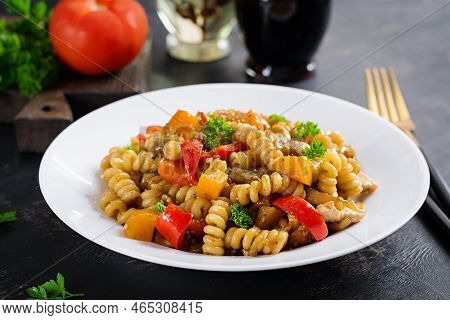Vegetable Pasta Fusilli Corti Bucati With Eggplant, Sweet Pepper And Chicken In White Plate On Dark 