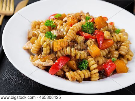 Vegetable Pasta Fusilli Corti Bucati With Eggplant, Sweet Pepper And Chicken In White Plate On Dark 