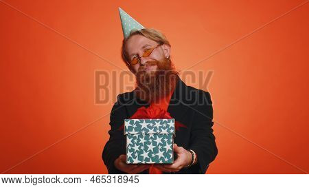 Positive Smiling Bearded Man Presenting Birthday Gift Box Stretches Out Hands, Offer Wrapped Present