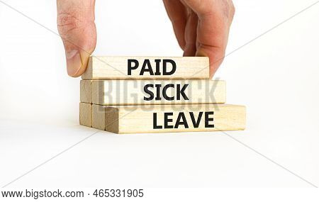 Paid Sick Leave Symbol. Concept Words Paid Sick Leave On Wooden Blocks. Doctor Hand. Beautiful White