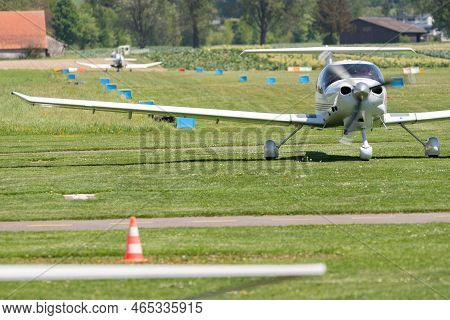 Lommis, Switzerland, May 11, 2022 Diamond Da40d Propeller Plane Is Rolling On A Small Airfield
