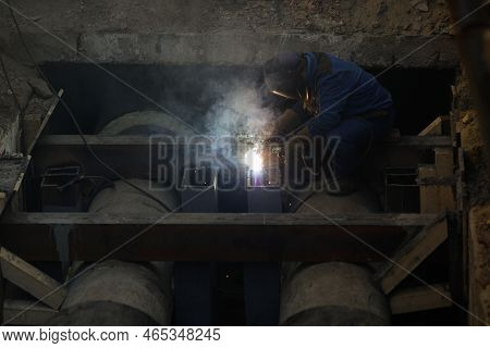 Details With A Professional Welder Welding An Industrial Metallic Pipeline.