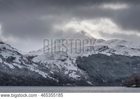 Beautiful Winter Landscape Image Of Snow Covered Trees On Shores Of Loch Lomond With Ben Lomond Moun