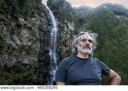 Man Under The Froda Waterfall In Sonogno, Switzerland