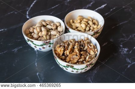 Three Bowls Of Christmas Godies On The Table.