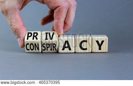 Privacy Or Conspiracy Symbol. Businessman Turns Wooden Cubes And Changes The Word Conspiracy To Priv