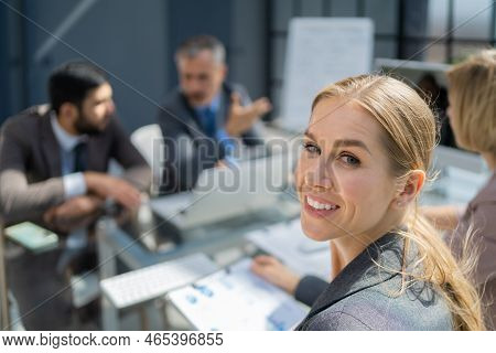 Face Of Beautiful Woman On The Background Of Business People.