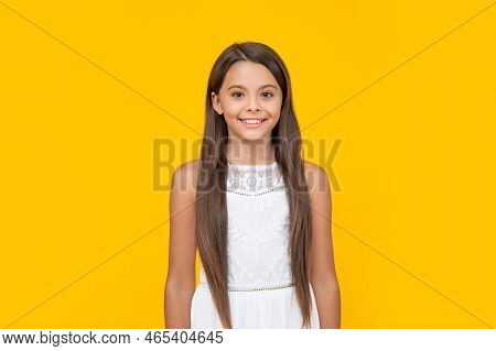 Cute Teen Girl In White Dress Has Long Hair On Yellow Background