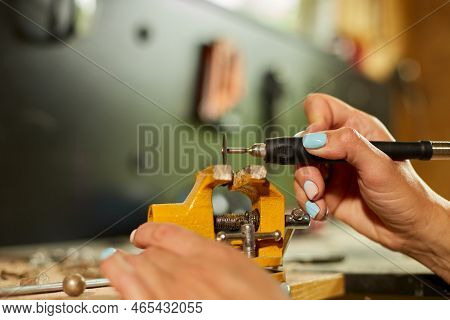 Woman Using Power Working Grinder Machine, Female Hand Grinds A Metal Nuts