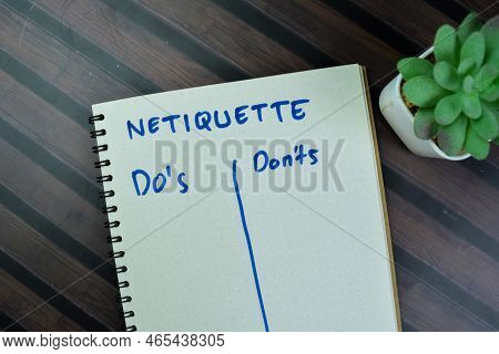 Concept Of Netiquette With Do's And Don'ts Write On A Book Isolated On Wooden Table.