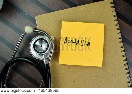 Concept Of Aphasia Write On Paperwork Isolated On Wooden Table.