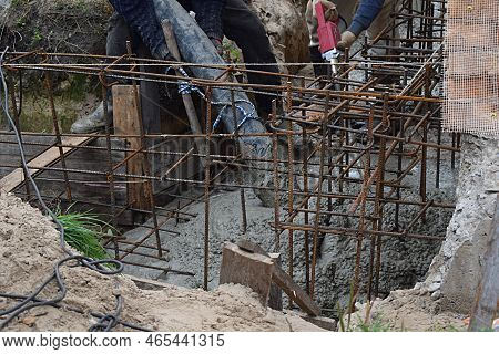 Pouring The Foundation With Concrete Using A Concrete Pump.