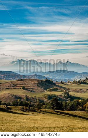 Mountain Scenery With Green Pastures And Rocky Tatra Mountains In The Background During The Day.