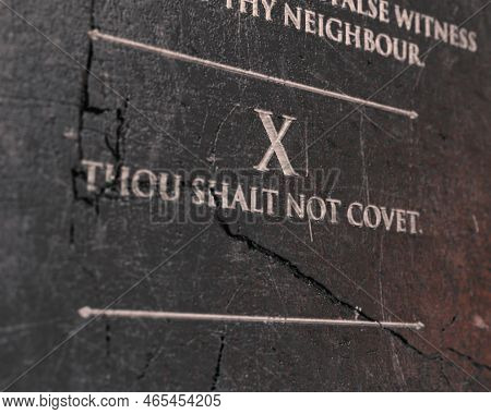 A View Of The Tenth Commandment Etched Into A Cracked Stone Tablet On An Isolated Background - 3d Re