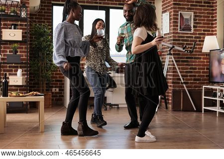 Different Cultures, Ethnicities People Group Dancing Together In Circle At Center House Living Room.