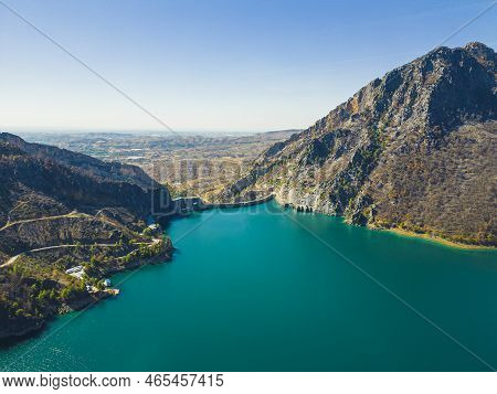 Rocky Mountains Above Oymapinar Lake, Turkey In The Morning. Deep Blue Water Lake. Blurred Hills In 