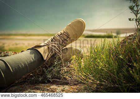 Feet Shod In Lace-up Shoes For Travel And Trekking On The River Bank In Safari Style
