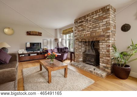 Fen Ditton, England - Jan 10 2019: Modern Luxury Furnished House Living Room With Brick Fireplace An