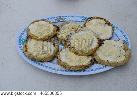 Above Image Of Plate Of The Mexican Dish Called Sopes Or Picadas, On A White Table