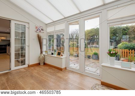 Newmarket, Suffolk, England - Feb 8 2019: White Upvc Conservatory Garden Room With Doors Leading To 